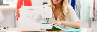 Person cleaning a Husqvarna Viking sewing machine with a brush