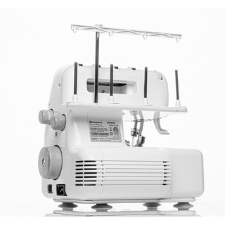 The Husqvarna Viking Amber S100 Overlock Machine by Husqvarna Viking, shown from the back and side against a plain background, features 4/3/2 thread capability, four vertical thread holders, control dials, and multiple ports.