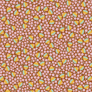 Tilda Wallflower Bellflower by 15-Brewer features a brown background with small pink pebble shapes and scattered yellow, green, and blue floral elements. Available by the yard—ideal for Tilda-inspired projects.