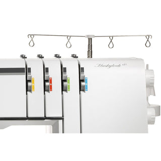 Close-up of the Husqvarna Viking Huskylock S21 overlock machine by Husqvarna Viking, featuring four color-coded thread tension dials and a metal thread stand on top.