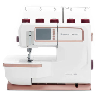 The Sew & Vac Husqvarna Viking Amber Air S600 is a white and rose gold sewing and overlock machine featuring a digital display and multiple thread spools on top.