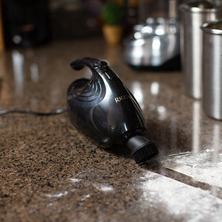 A Riccar GEM Handheld Vacuum on a Gem counter top.