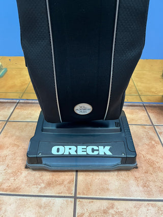 An upright Sew & Vac Oreck XL21 vacuum cleaner with a HEPA CC bag standing on a tiled floor.