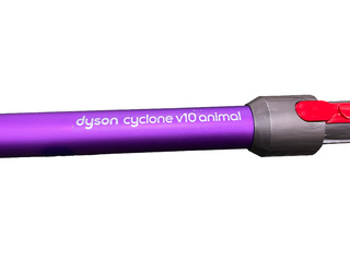Close-up of a certified refurbished Dyson Cyclone V10 Animal vacuum cleaner. The purple tube displays the Sew & Vac brand name alongside the model in white text, and includes a charger for added convenience.