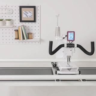 A Husqvarna Viking sewing machine on top of a desk.