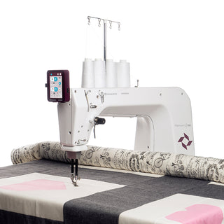 A Husqvarna Viking sewing machine with a quilt on top of it.