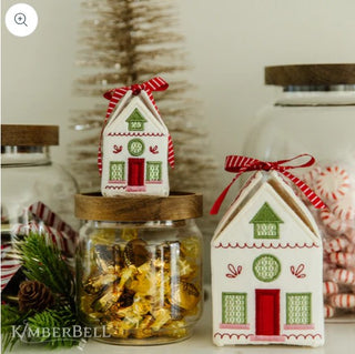Two jars of candy with a Christmas house in them, featuring the Kimberbell DDE- mach emb design, exclusive to Sew & Vac.
