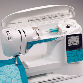 A Husqvarna Viking sewing machine with blue and white fabric.