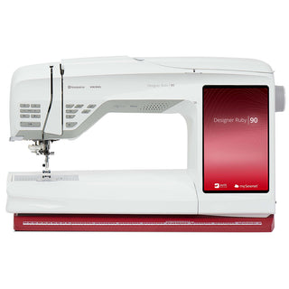 The 38-SVP - Singer Viking Pfaff Husqvarna Viking Designer Ruby 90 is a white sewing and embroidery machine featuring ribbon embroidery capabilities and a large red touchscreen display on the right.