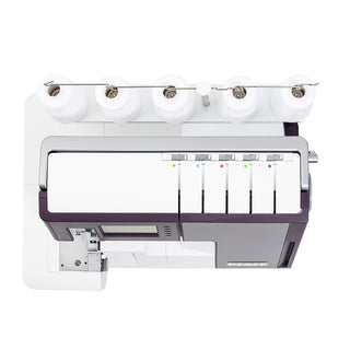 A Pfaff Admire Air 7000 sewing machine with several bobbins and threads.