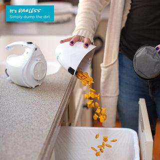 A woman is putting Simplicity FLASH Micro Vacuum into a bag.
