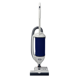 The SEBO Dart w/ET-1 Power Head (White) is an upright vacuum cleaner featuring S-Class sealed filtration, a hose at the back, power button on the handle, and a stylish white and blue design.