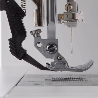 A PFAFF Ambition 620 Sewing and Quilting Machine with a needle attached to it.
