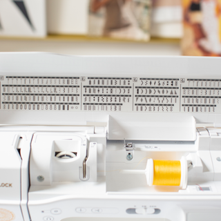 A Baby Lock Brilliant Sewing Machine with a needle and thread in it.