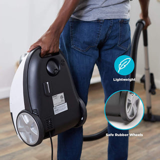A person holds the simplicity Jill Canister Vacuum Cleaner, showcasing its powerful suction, lightweight carry design, and safe rubber wheels in close-up shots.
