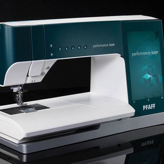 The PFAFF Performance Icon sewing machine features a touchscreen display and the largest working area, shown on a dark reflective surface.