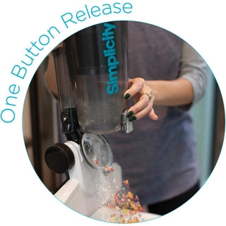 A person using a Simplicity S60 Spiffy Broom Vacuum with the text one button release.