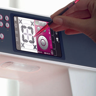 A hand selects exclusive embroidery designs and patterns with a stylus on the touchscreen of the PFAFF Creative 3.0, featuring innovative Exclusive Stitch Creator technology.