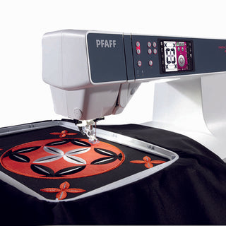 The PFAFF Pfaff Creative 3.0 embroidery machine stitches a detailed red and black geometric pattern on black fabric, highlighting intricate designs made with the Exclusive Stitch Creator.
