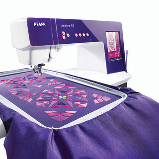 A PFAFF Creative 4.5 Sewing, Quilting, and Embroidery Machine with a purple fabric on top of it.