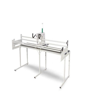 A white table with a Baby Lock Gallant with Villa Frame on top of it.