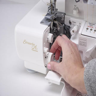 A person is using a Baby Lock Accolade Serger sewing machine to sew a piece of fabric.