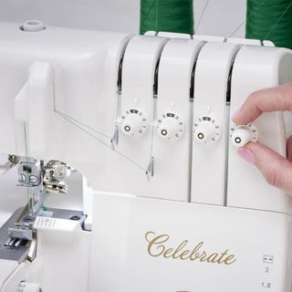 A person is using a Baby Lock Celebrate Serger sewing machine to sew a piece of fabric.