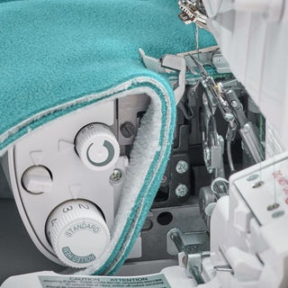 A close up of a Baby Lock sewing machine with a blue cover.