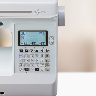 A white Baby Lock Lyric Sewing & Quilting Machine on a table.