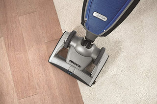 A vacuum cleaner on a hardwood floor.
