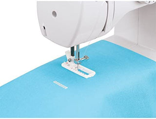 A sewing machine with a blue fabric on top.