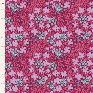 The Tilda Hibernation AUTUMNBLOOM OLD ROSE TIL100529 Fabric by Tilda features vintage cotton with a red background, purple and turquoise flowers, autumn motifs, and an inch ruler along the left edge.