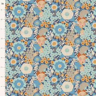 Tilda Wallflower Blue TIL100607 Fabric by Tilda is a 100% cotton fabric featuring large blue, white, and orange floral prints with women’s faces among the flowers; a ruler appears along the left edge.
