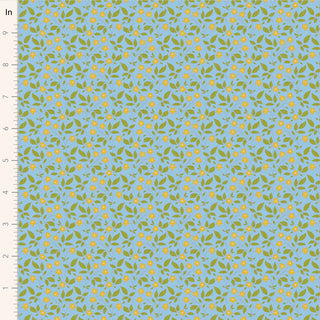 Tilda Sunday Brunch Blender TIPSY SKY TIL110124 by Fabric by Tilda features a blue background with green leaves and small yellow flowers, shown with an inch ruler for scale. Perfect for premium quilting cotton projects.