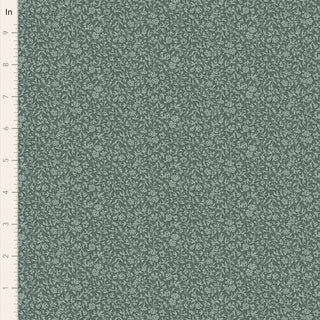 Tilda Merry Little Christmas 110142 Blender Eve Petrol Fabric by Tilda features green fabric with a small, repeating floral pattern and includes a centimeter ruler along the left edge for scale.
