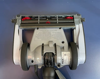 A Sew & Vac Oreck Magnesium LW1500RS vacuum cleaner on a blue surface.