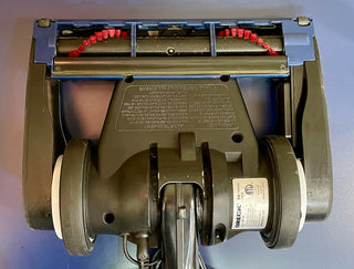 A certified reconditioned Sew & Vac Oreck Magnesium LW100 vacuum machine on a blue surface.