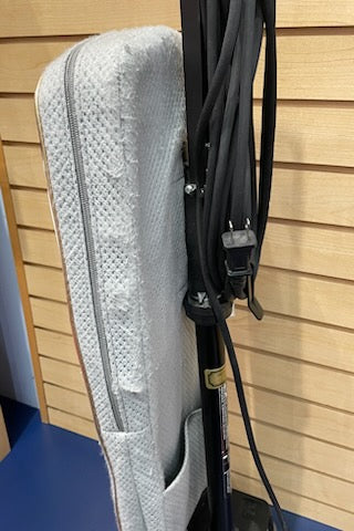 White Oreck XL vacuum cleaner in great condition leaning against a wall beside a coiled black cable.
