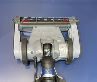 A Certified Refurbished Oreck Magnesium vacuum cleaner with a handle attached to it, featuring like-new parts by Sew & Vac.