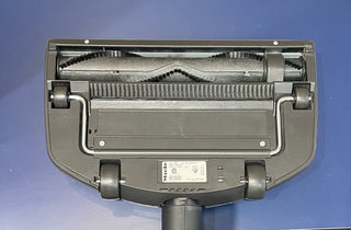 Close-up of the underside of a Sew & Vac C3 Miele Brilliant vacuum cleaner, showing the brush roll and model information label.