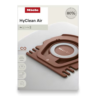 Box of 2-Miele CO HyClean FilterBags - 4 Count featuring an image of a brown vacuum bag, product name, and icons illustrating key features. This essential accessory includes four Miele CO HyClean FilterBags, designed for optimal filtration and performance.
