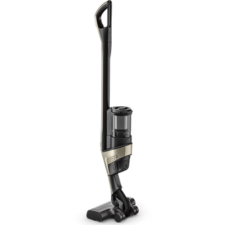 The Miele Triflex HX3 Plus Cordless Stick Vacuum by 2-Miele stands upright on a white background, featuring a slim design with a titanium pearl (black and metallic) finish, a HEPA filter, and a transparent dustbin.