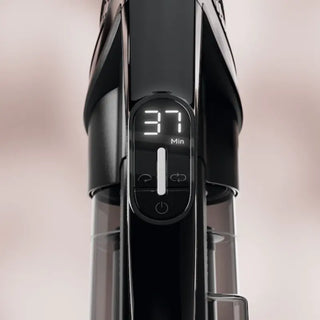 Close-up of the Miele Triflex HX3 Cordless Stick Vacuum in Brilliant White, featuring a digital display indicating “37 Min” and control buttons located beneath the screen.