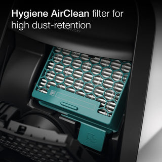 Close-up of a Miele Boost CX1 Pure Suction Hygiene AirClean filter inside this 2-Miele bagless canister vacuum, featuring a teal plastic casing and hexagonal mesh pattern for high dust retention.