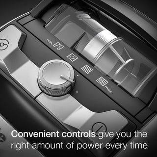 Close-up of the 2-Miele Boost CX1 Pure Suction control panel with a power knob set between min and max, and labeled icons above the dial; text reads, “Convenient controls give you the right amount of power every time”—perfect for adjusting your bagless canister vacuum with Vortex technology.