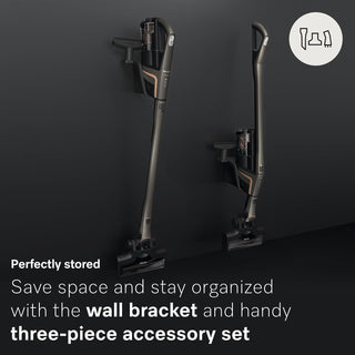 Two Miele Triflex HX2 Pro 3-in-1 Cordless Stick Vacuums from 2-Miele, each boasting a versatile space-saving design, are securely mounted on the wall with robust brackets; accompanying text emphasizes efficient storage options and the practicality of a three-piece accessory set—making these cordless uprights ideal for keeping organized homes tidy.