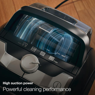 Close-up of the 2-Miele Boost CX1 Cat & Dog bagless vacuum cleaner featuring a visible dust canister, power dial, and easy-to-read icons. Text reads: “High suction power. Powerful cleaning performance—perfect for removing pet hair.”.