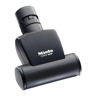 The Miele STB 101 Handheld Mini Turbobrush by 2-Miele is a black vacuum cleaner attachment featuring a rotating brush, specifically designed for cleaning upholstery and small surfaces—a versatile accessory ideal for effortless maintenance of your home’s fabrics and furniture.