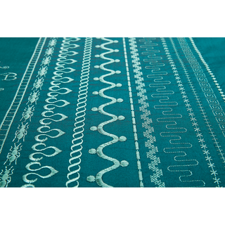 Close-up of teal fabric with rows of white geometric and decorative embroidery designs, created using advanced stitch customization on the 38-SVP - Singer Viking Pfaff Pfaff Creative Expression 750 embroidery machine.