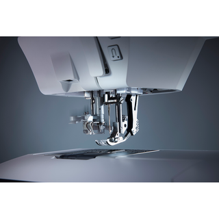 Close-up of the Pfaff Creative Expression 750 needle and presser foot by 38-SVP - Singer Viking Pfaff, showcasing detailed metal parts and advanced stitch customization in optimal lighting.